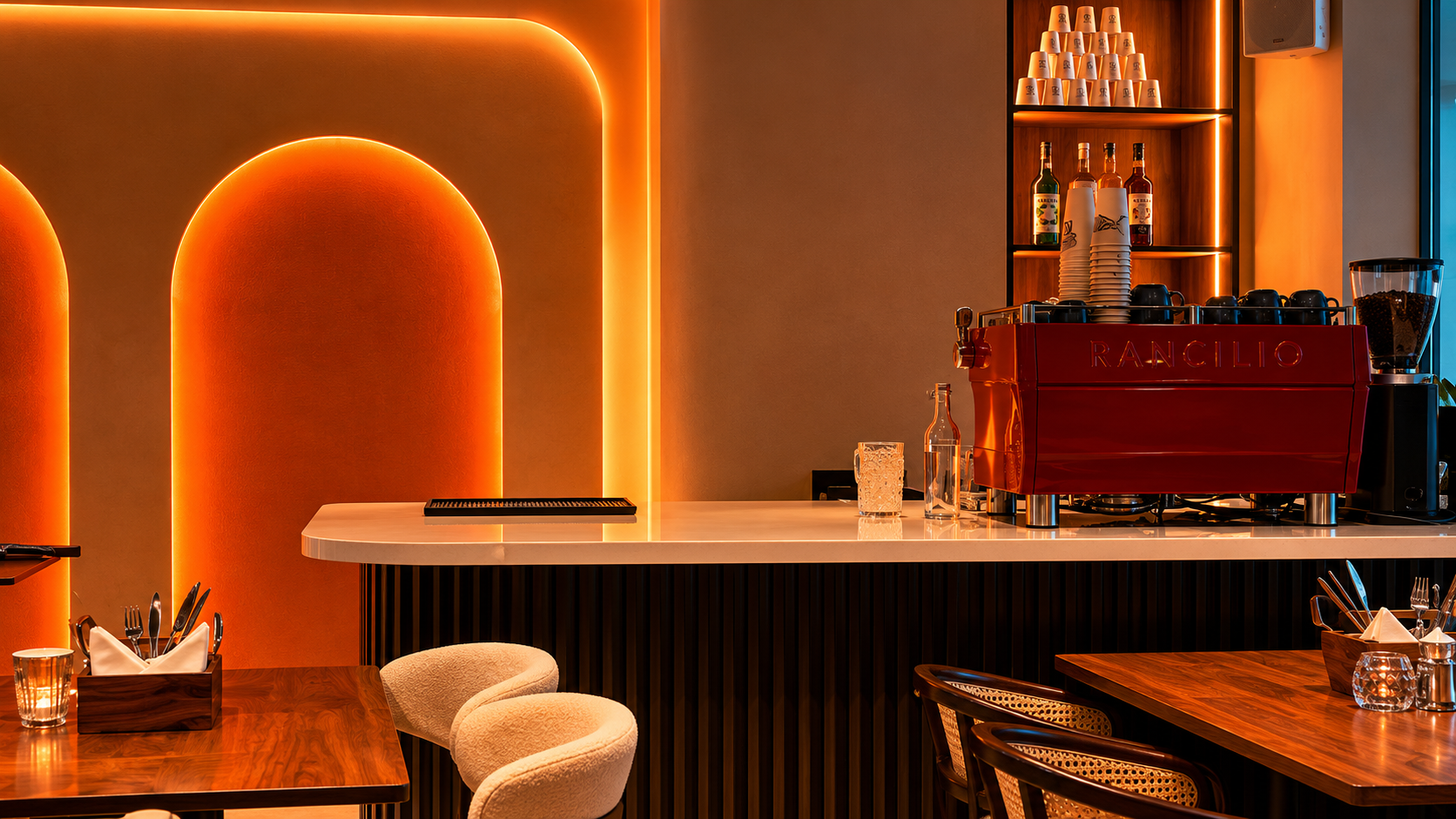 OMIRA interior — warm amber-lit space in Indiranagar, Bangalore